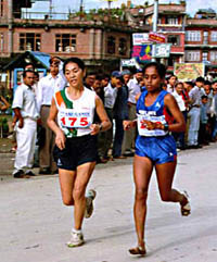 India's Rigzan Angrid, left, races with Sri Lanka's D.A. Inoka on a Katmandu street during the women's marathon in the seven-nation South Asian Federation Games 