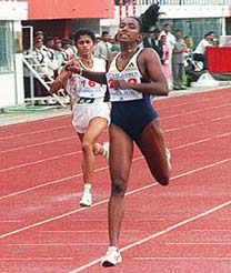 Sri Lankan Athlete Damayanthi Darsha (R) takes lead from her Indian competator K.M.Beenamol after the finish line of the women's 400 meter race in the 8th SAF Games in Kathmandu on Monday