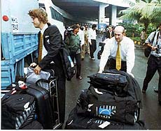 New Zealand's cricket team members transfer their luggage to a bus on their arrival in Mumbai on Monday morning