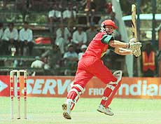 Zimbabwe batsman Andy Flower hooks a ball from South African bowler Derek Crookes, for four