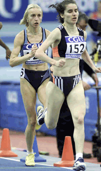 Romania's Gabriela Szabo (left) runs behind a pacemaker as she attempts a world record in the indoor 3,000 meters at Birmingham England on Sunday