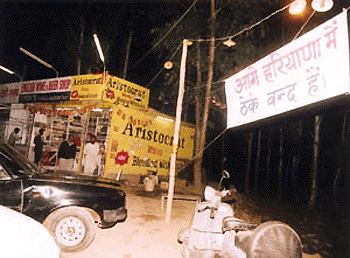 With the Haryana Government having closed liquor shops in the state due to the elections, liquor traders in the city have displayed banners near the Haryana-Chandigarh border to attract buyers to purchase their quota of liquor. Tribune photo by Parvesh Chauhan