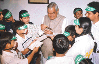 Prime Minister Atal Behari Vajpayee interacts with a group of school children who presented him a manifesto on clean air as a part of the Earth Day 2000 celebrations in New Delhi on Saturday