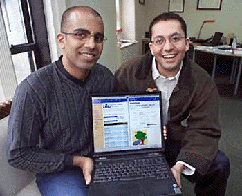 Raj Yersai (left) and Sumit Kapur, young Indian businessmen who founded a web auction site to sell American products back home, show off the home page of their site, left side of screen, and a piece of artwork up for auction, on the right in their New York office. Keeping one foot in the USA and the other in India is allowing a trickle of entrepreneurs to take advantage of the growing connections between the two countries’ technology industries. — AP
