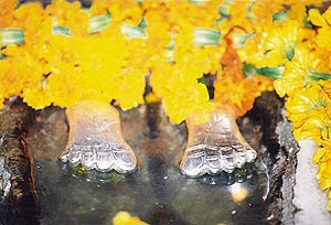 The silver-crested Charan Paduka of the deity 