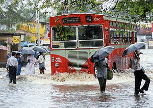 A best public transport bus winds itself through the water logged road as pre-monsoon showers threw normal life out of gear