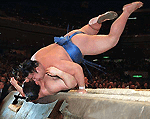 Chiyotaikai, top, overthrows grand champion Takanohana on Friday in the 15-day Summer Grand Sumo Tournament in Tokyo. Takanohana suffered second loss 11-2 and Chiyotaikai 10-3