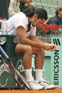 Chilean Marcelo Rios sits on a chair after giving up his first round match against German Tommy Haas on Wednesday at the French Open following a thigh injury.