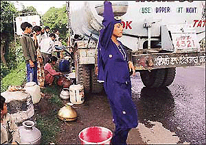 Kol dam notwithstanding , this is the plight of the people of Barmana in Bilaspur district of Himachal Pradesh for whom carrying water from tankers to their distant houses is an everyday occupation.  Tribune photo by Karam Singh