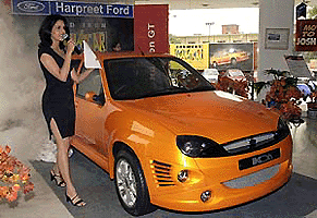 A model presents a Ford Ikon GT Model during an unveiling ceremony in New Delhi on Thursday. With modifications designed by Dilip Chhabria, Ikon GT is yet another addition to the countrys expanding small to medium car market which latecomer Ford hopes to stake a claim in.  AFP photo