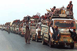A caravan of vehicles, carrying Afghan refugees, prepare to leave Karachi for Afghanistan.