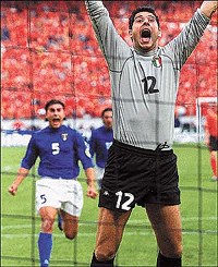 Italy's goalkeeper Francesco Toldo celebrates saving a penalty shot from Frank De Boer of the Netherlands with teammate Fabio Cannavaro during their semi final European Championship match in Amsterdam on Thursday
