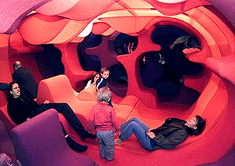 Visitors sit and admire the “Fantasy Landscape” designed by German Bayer AG in 1970 for a furniture fair, which has been partially reconstructed and is on display in the newly-opened Vitra Design Museum in Berlin on Sunday