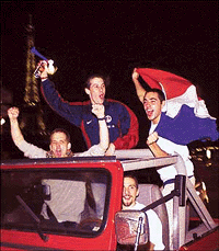 Parisians celebrate victory near the Eiffel Tower as they ride in a jeep through Paris  Reuters photo