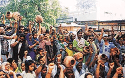 Residents of kidwai Nagar carrying empty pitchers hold a demonstration against water shortage in Ludhiana on Friday —Photo by Rajesh Bhambi