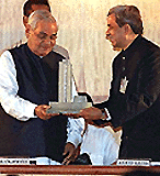 Prime Minister Atal Behari Vajpayee being presented a glass memento of the stock exchange by Anand Rathi president of the BSE, in Mumbai on Sunday.   PTI photo