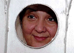 Kulsoom  Sharif,  peeps through the hole of  the gate of her residence in Lahore on July 10, 2000.