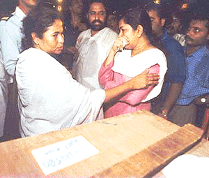 Union Railway Minister Mamta Banerjee  consoles Soma Dey beside the coffin of her husband Sandip Dey at the Calcutta airport on Tuesday. Sandip Dey one of the victime of the air crash in Patna on Monday