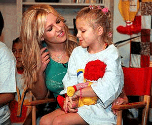   SAN ANTONIO : Pop singer Britney Spears talks with Taylor McClintock, a resident of the Ronald McDonald House of San Antonio, Thursday, July 20, 2000.  Spears, in San Antonio to give a concert Thursday night, visited the Ronald McDonald House to promote an upcoming CD  and video release with other top international artists including NSYNC, Sisqo and Enrique Iglesias. AP/PTI