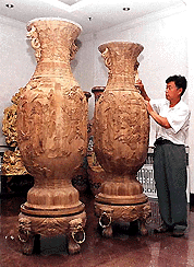 Two vases carved from wood are displayed in Mudanjiang city, in China's Heilongjiang province, on Saturday. The 6-feet tall vases each depict a scene from the Chinese literary work, "Dreams of the Red Mansion".  AP/PTI photo