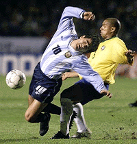 Ariel Ortega (L) of the Argentine national soccer team is fouled by Roberto Carlos of Brazil during their sixth qualifying match for the 2002 World Cup, in the Morumbi Stadium on Wednesday