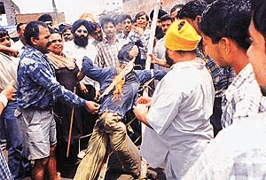 Shopkeepers of Circular Road burn an effigy of Pakistans military ruler Gen Parvez Musharraf in Ludhiana on Wednesday to protest against the killings of pilgrims of the Amarnath yatra.
