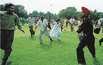 Punwire employees being lathi-charged at the CHB roundabout in Chandigarh on Wednesday. Tribune photo by Pradeep Tewari
