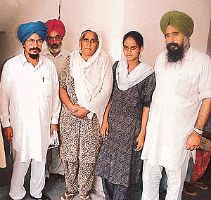 Mr Tarsem Jodhan (second from left) with the parents of the youths who died after taking Celphos tablets in Khera village, at a press conference in Ludhiana on Saturday. Photo by Rajesh Bhambi