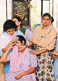 Widow of Harjinder Singh being consoled by relatives  Tribune photo by Pradeep Tewari
