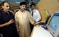 Indian Minister for Information Technology  Pramod Mahajan tries out a computer during the inauguration of the Centre for E-governance in New Delhi on Tuesday. The centre is a showcase of various initiatives by India's IT ministry to ease dialogue through the Internet between government departments and the citizens. It also aims to improve performance within government departments through various Intranet networks. On his left is Arun Shourie, minister of administrative reforms and public grievances.  AFP photo