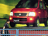 A woman walks past a billboard put up by one of Indias leading car manufacturers on Tuesday in New Delhi. The slide in the value of rupee against the US dollar has hit Indias automobile industry and could herald a significant increase in car prices. Global automobile giants such a Ford, General Motors, Daewoo and Fiat which have set up bases in India, still import some critical components, despite increased levels of local sourcing.  AFP photo
