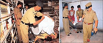 Grisly end: A cop covers the body of one of the deceased with a sheet; (right) policemen bring out the body of another deceased, which was dumped in the bathroom of the liquor vend in Sector 24 of Chandigarh on Thursday. — Tribune photos by Manoj Mahajan