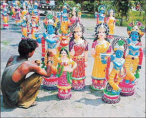 Rawat Ram gives finishing touches to these idols of Lord Krishna and Radha near GT Road, Ludhiana.  Photo by Rajesh Bhambi