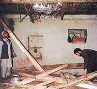 Villagers assess damage caused to a house after it was hit by an artillery shell fired by Pakistani troops in Busgran village in the Uri sector, 102 km north-west of Srinagar, on Thursday.