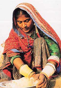 A Rabari woman kneading dough