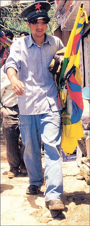 Mission to accomplish: A refugee walking with the Tibetan flag