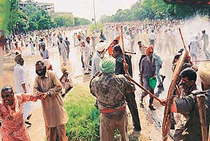Agitating farmers from Punjab are dispersed by water cannon and a mild cane charge in Sector 17, Chandigarh, on Tuesday.