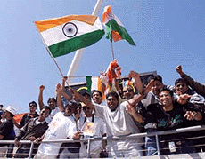SYDNEY : Indian fans wave the national flag as they celebrate their men's hockey team's win over Argentina in preliminary competition at the Olympic Games in Sydney Sunday. India won 3-0. — AP/PTI 