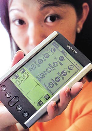 Sony Corp's Yoko Dobashi shows off the electronic maker's new digital organiser, the CLIE, at Sony headquarters.