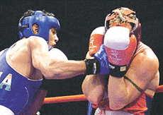 Indias Jitender Kumar (left) hits Canadas Donald Grant Orr.