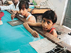 Many children like Yaseen and Raja work for about 16 hours a day for meagre wages in the suffocating environment of various embroidery units in Ludhiana.  Photo by Rajesh Bhambi