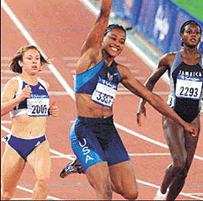 Marion Jones from the USA celebrates her win .