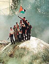 Palestinians put their flag on top of Josephs Tomb after an Israeli withdrawal from the holy site in Nablus, on Saturday. 