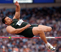South Africa's Fanie Lombaard attempts to squeeze himself over the bar on the way to fifth place in the high jump section of the men's pentathlon P42 at the 11th Paralympics Summer Games in Sydney, on Sunday.