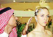 Bahraini Ali Khalifa al-Hammadi gets a close look at a $ 50,000 white gold head piece by Italian designer Carrera, worn by a model at an exhibition in Manama, Bahrain, on Tuesday. 