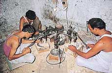 A family affair: Three brothers operating an electric drill for 