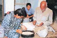 All in a days work: A young girl, back from school, helps 