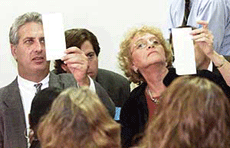 Mr Charles Burton, chairman of the Palm Beach County and Ms Carol Roberts, both members of the county's Board of Elections, view ballots during the manual and machine recount of votes on Saturday. 