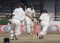 Indian batsman Ajit Agarkar (R) drives a ball off Naimur Rahman (not in picture) as wicketkeeper Khaled Masud (L) and other batsman Sunil Joshi (C) watch on the fourth day of the first ever Test in Dhaka's Bangabandhu Stadium on Monday. India scored 429 all out in the first innings.