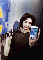 Mary Starman of Microsoft holds a new generation pocket PC from Compaq during the first day of the COMDEX convention in Las Vegas, Nevada, on Monday.
